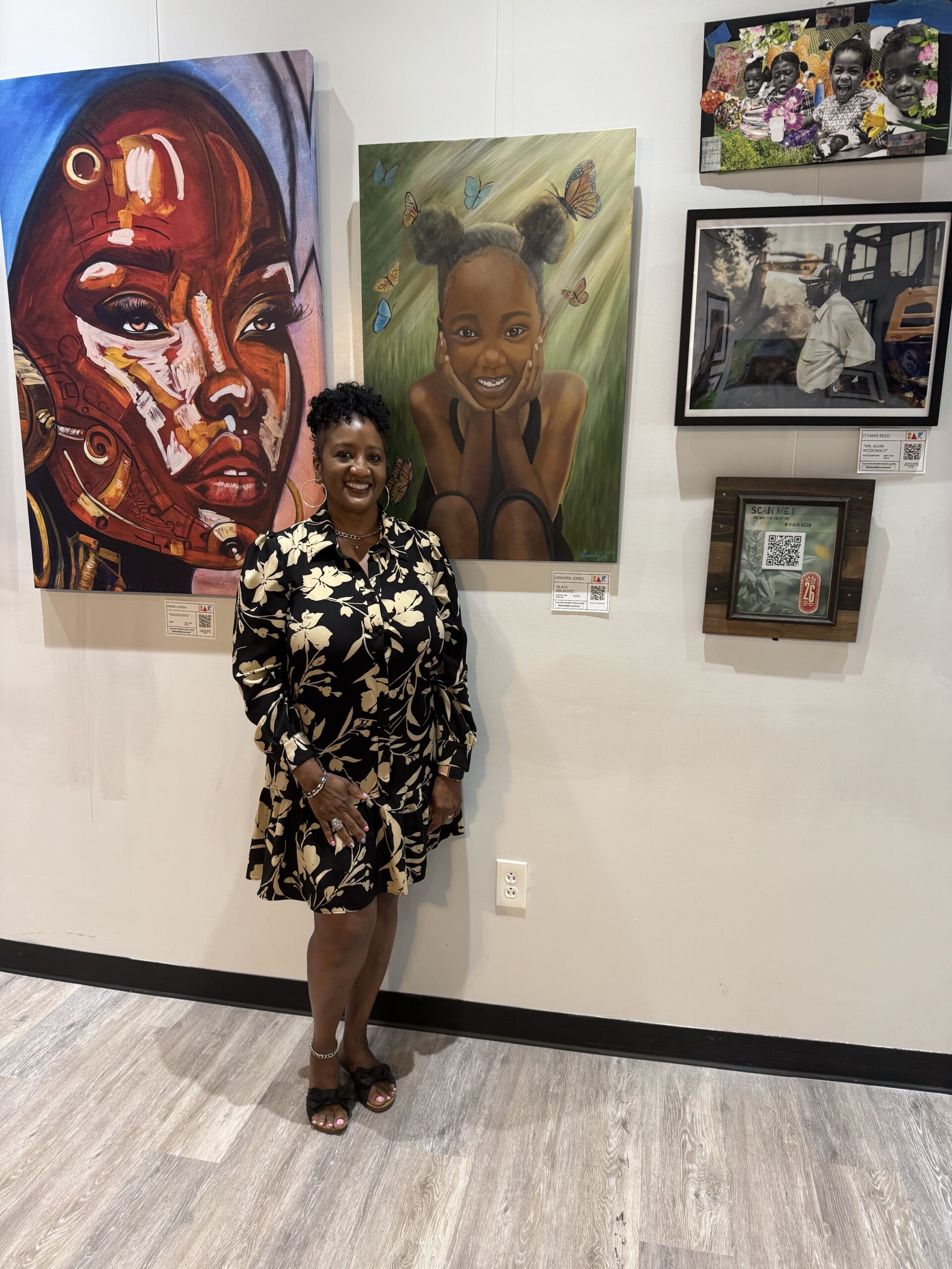 Ms. Jones standing in front of her painting at Black Artist Forward Exhibition