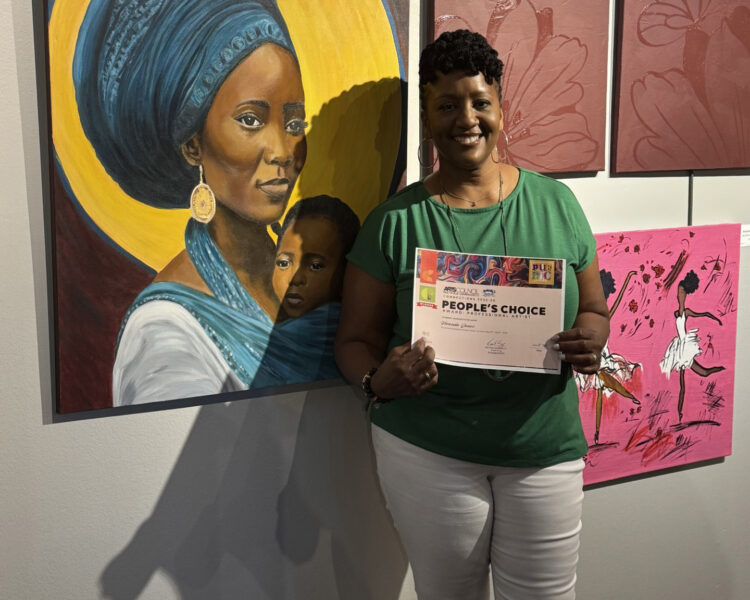 Ms. Jones holding up Award next to painting