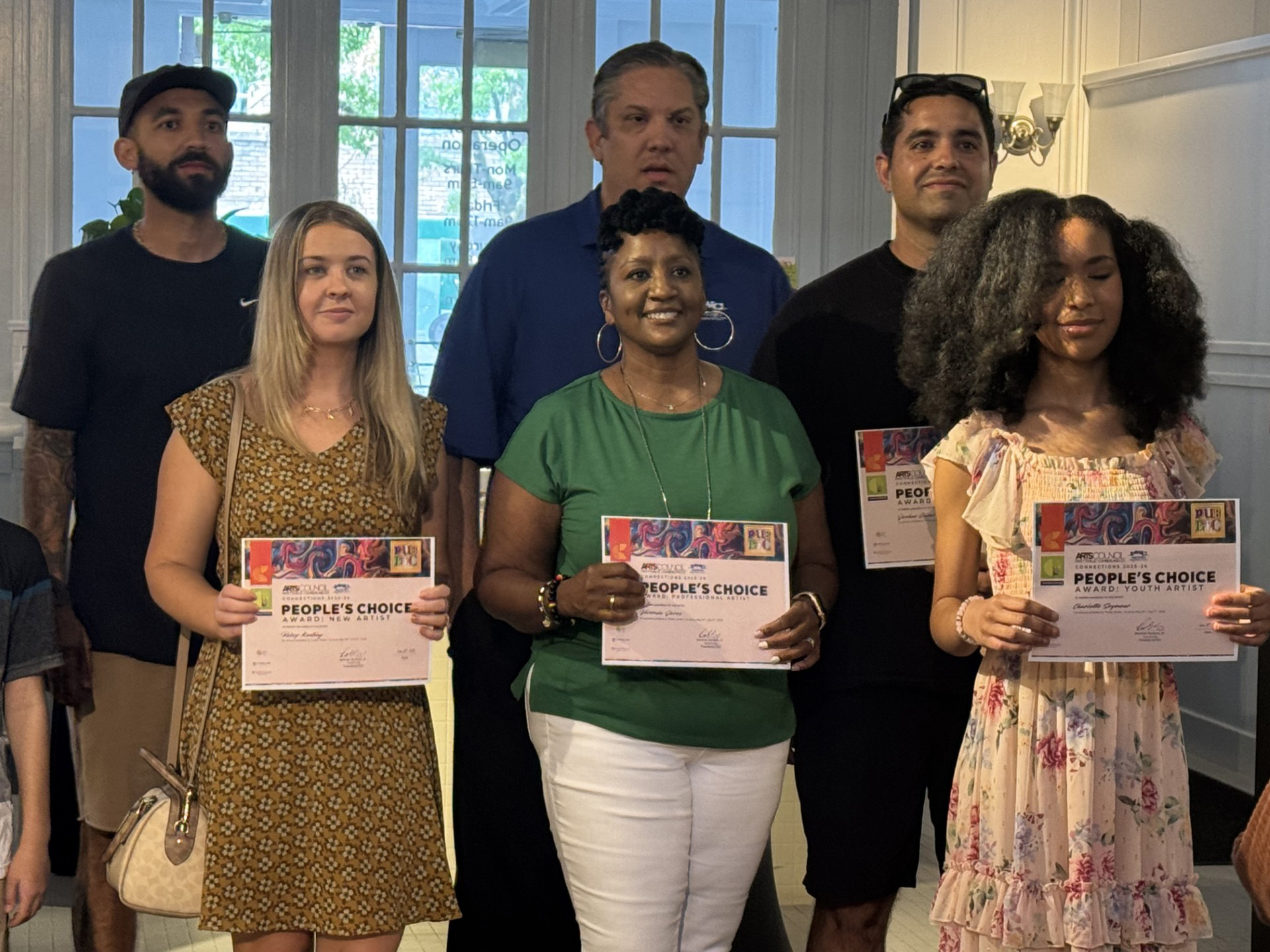 Group of people holding up Awards