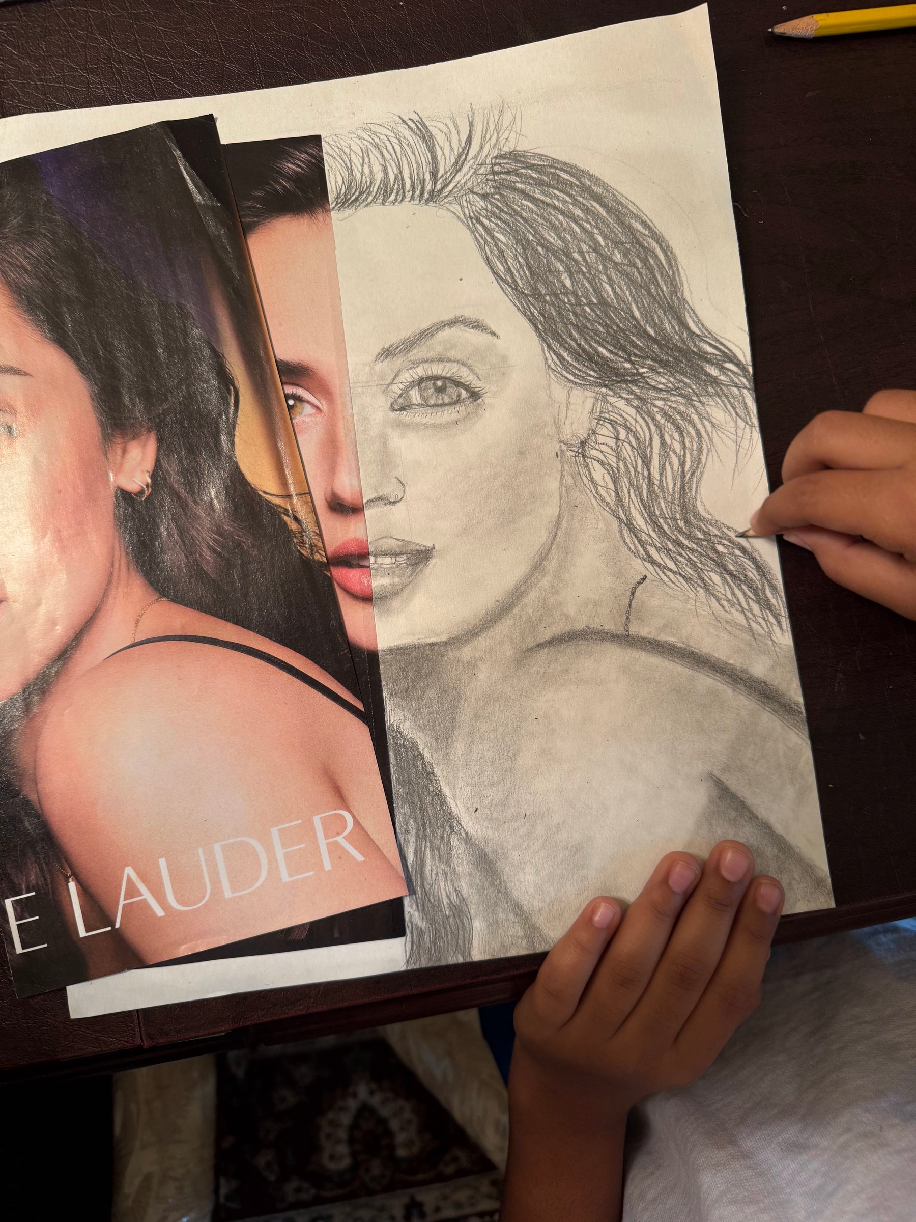 Student drawing a graphite portrait from a photo in a private art class